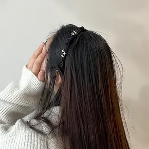 Detail of elegant black fabric headband with sparkling star rhinestones on long hair