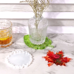 DIY silicone mold for resin coasters with finished maple and monstera leaf designs