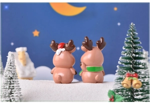 Miniature resin Christmas reindeer figurines in a snowy night landscape for DIY micro gardens