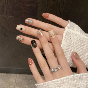 Handmade press-on nails with mother-of-pearl shell fragments and cat-eye glitter design