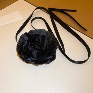 Detailed view of a handmade 3D black lace fabric camellia flower choker with long ribbons