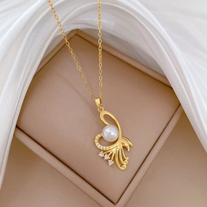 Elegant gold titanium necklace with pearl and rhinestones on soft silk fabric background