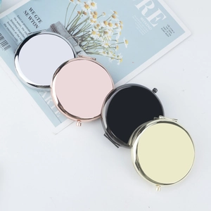Set of four circular metal folding mirrors in silver, rose gold, black, and pale gold