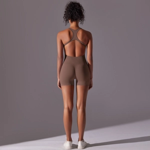 Detail view of earthy brown backless yoga bodysuit with cross-back design and premium fabric