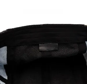 Detailed view of the 100% cotton care label and stitching inside the denim beret cap