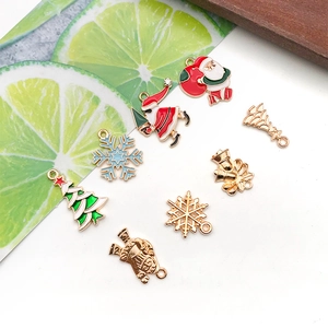Flat lay of colorful Christmas alloy enamel pendants including Santa and snowflakes