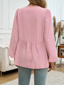 Detail of red and white striped long sleeve peplum shirt showing back view and pleated hem