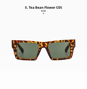 Close-up of tortoise shell square sunglasses with dark green lenses and C05 DEMI logo