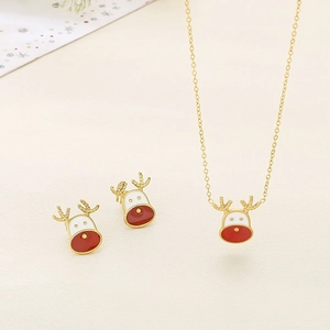 Detail of Christmas reindeer necklace and stud earring set with red enamel in gold finish