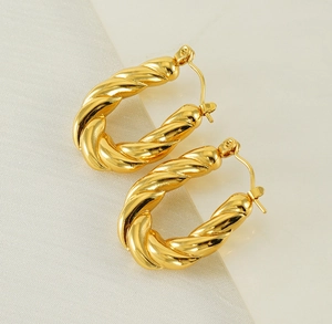 Detailed close-up of 18K gold-plated twisted rope hoop earrings with a secure clasp