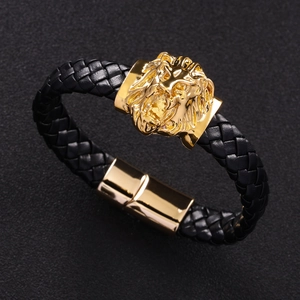 Detail of black braided leather bracelet with golden lion head and magnetic clasp