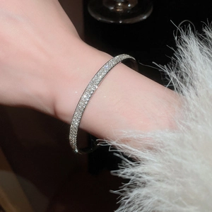 Close-up of elegant silver bracelet with sparkling pavé-set rhinestones on a wrist