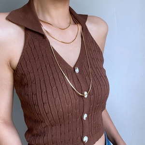 Close-up of a double-layered gold snake chain necklace on a model for a minimalist style