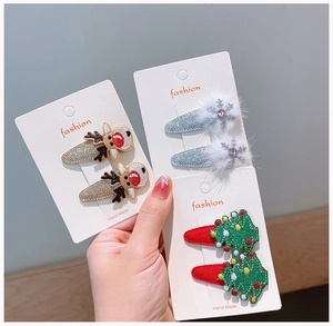 Detailed view of handmade Christmas hair clips with reindeer, snowflake and tree motifs