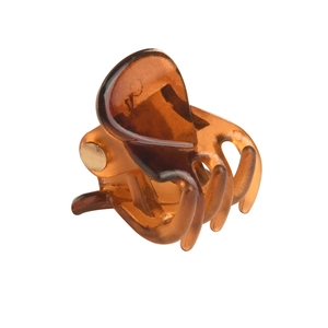 Detail shot of mini amber translucent resin hair claw clip with metal spring mechanism