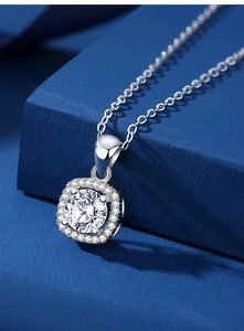 Close-up of S925 sterling silver necklace with square moissanite pendant on dark blue background