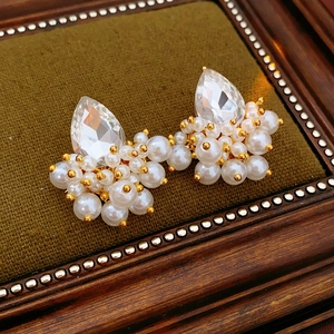 Detail of vintage French style water drop gemstone earrings with pearls and gold beads