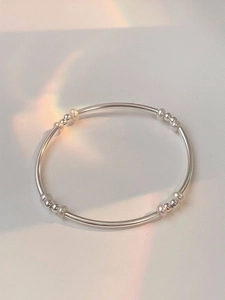 Detail of silver beaded bangle bracelet with elegant prism lighting effects