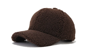 Detailed texture of a dark brown plush lamb wool baseball cap with vintage curved brim