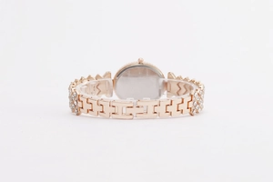 Close-up of rose gold watch strap featuring crystal-encrusted links and a folding clasp