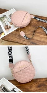 Detail of pink quilted round crossbody bag featuring branded wide textile shoulder strap