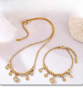 Macro detail of gold PVD electroplated necklace and bracelet set with Roman numerals