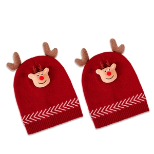 Two red Christmas knit hats with reindeer antlers and festive deer faces on a white background