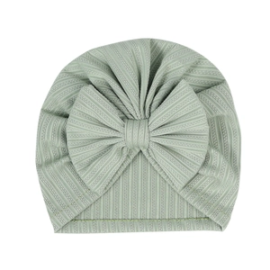 Macro detail of elastic ribbed knit newborn turban with a large soft decorative bow