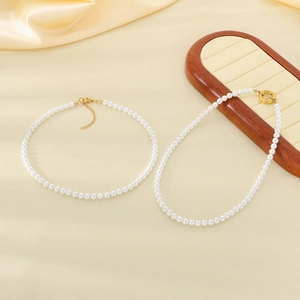 French vintage titanium steel necklace with white pearls on a silk background