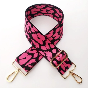 Macro view of 5cm wide leopard print jacquard bag strap with gold metal buckle