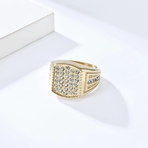 Macro shot of 18K gold plated hip hop ring with paved white cubic zirconia stones