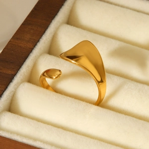 Close-up of 18K gold-plated adjustable ring on warm beige velvet jewelry display
