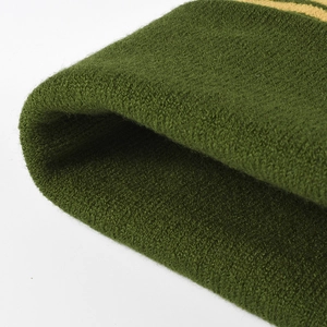 Winter stretch knit beanie for women in dark green and yellow with a thick pom-pom detail