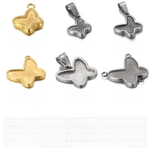 Detailed view of various butterfly-shaped stainless steel pendants in gold and silver steel tones