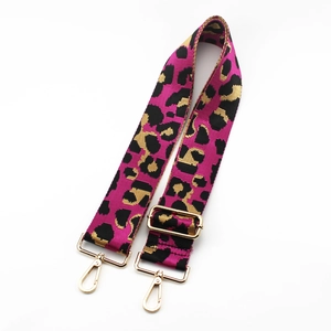 Close-up of leopard pattern bag strap with golden metal swivel hooks and adjustable buckle
