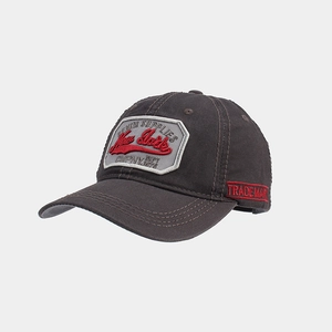 Detail of embroidered New York vintage patch on a dark grey cotton baseball cap