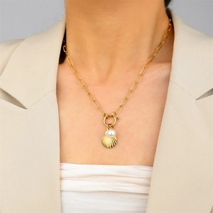 Detail of 18k gold plated paperclip chain with shell pendant and pearl on model