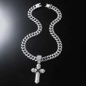 Iced out silver cross pendant with black X pattern on a shiny cuban link chain