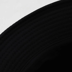 Detailed close-up of the black bucket hat brim showing multi-row parallel stitching