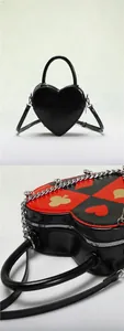 Detail of red and black poker print heart-shaped bags with chain straps and glossy finish