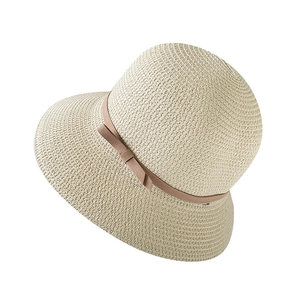 Beige woven straw sun hat with bow ribbon detail for women beach vacation style