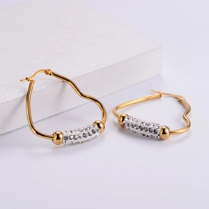 Elegant gold heart-shaped hoop earrings with sparkling crystal-encrusted cylinders