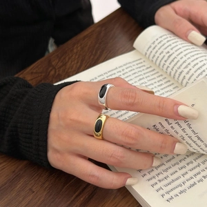 Detailed view of bamboo style silver ring with black onyx stone on vintage book