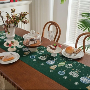 Christmas table runner with green candy jacquard and festive tassels decoration