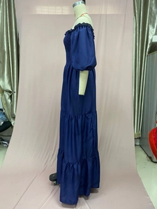 Detail of navy blue off-shoulder tiered dress with smocked bodice and puff sleeves