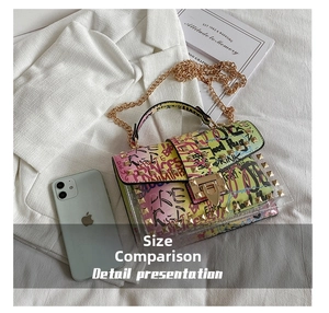 Detail of transparent graffiti jelly bag with gold rivets and metallic chain strap