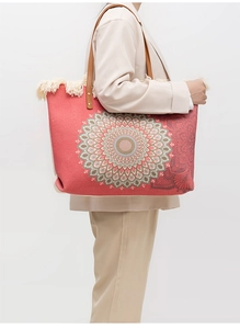 Detail of bohemian canvas tote featuring coral mandala print and decorative fringe
