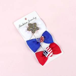 Detailed set of red, white, and blue patriotic ribbon bows on a jewelry display card
