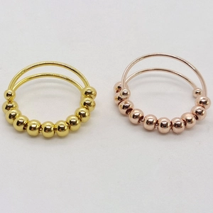 Adjustable stainless steel anti-anxiety spinner rings in gold and rose gold finishes