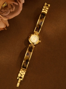 French vintage style women's watch featuring tortoise shell link band and gold case